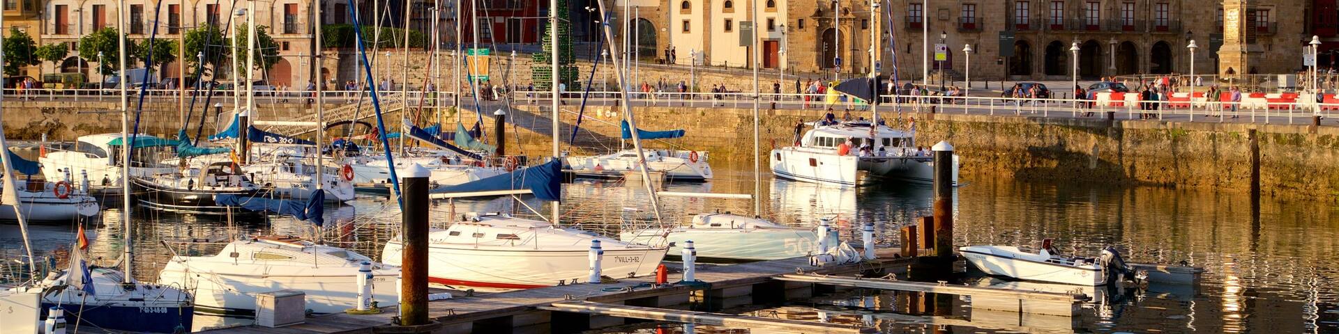 Gijon featuring a sunset, a city and a bay or harbor