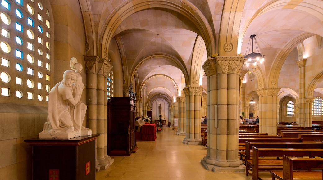 Gijon featuring interior views, a church or cathedral and a statue or sculpture