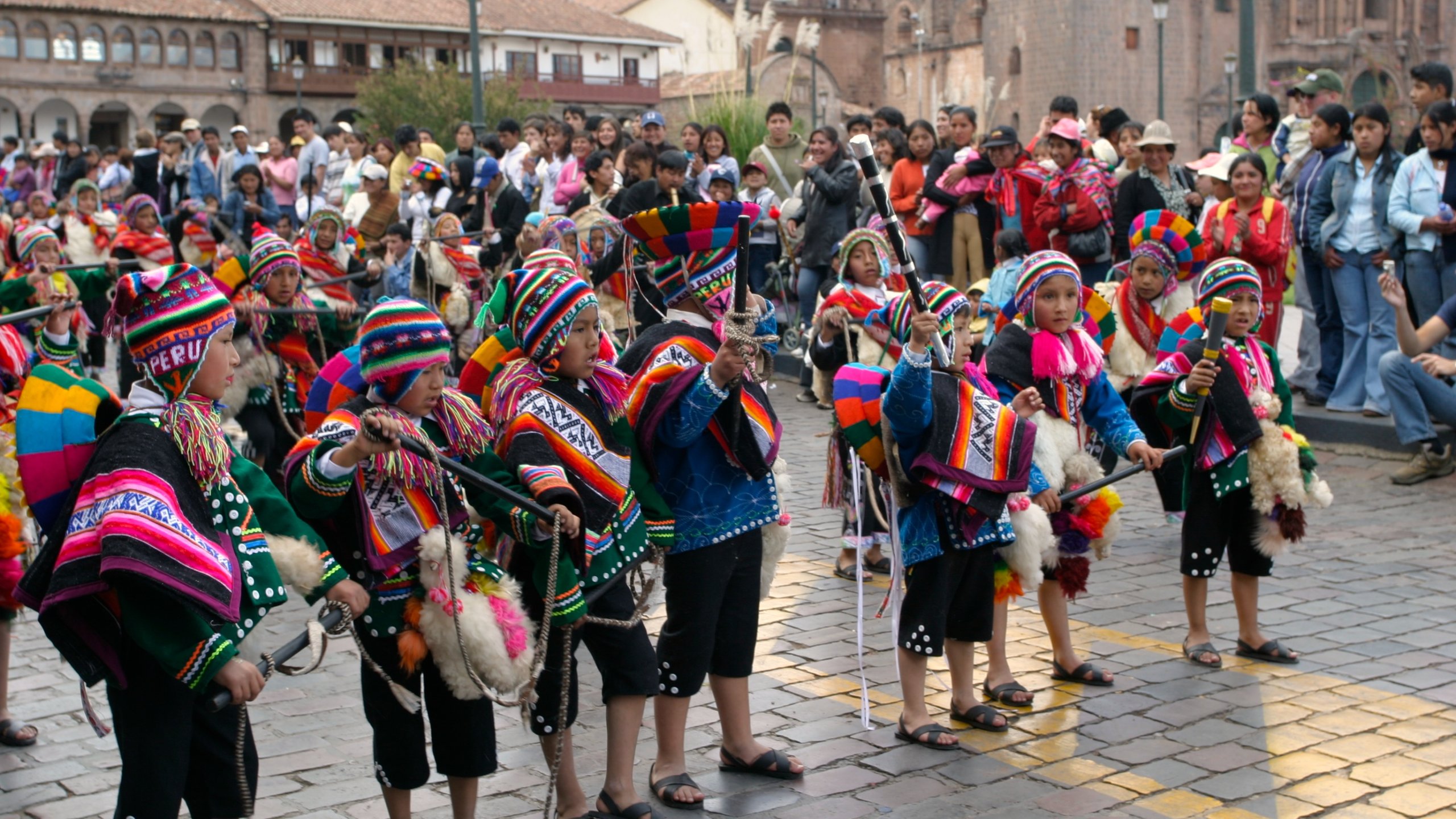 Cusco showing performance art, a festival and street performance