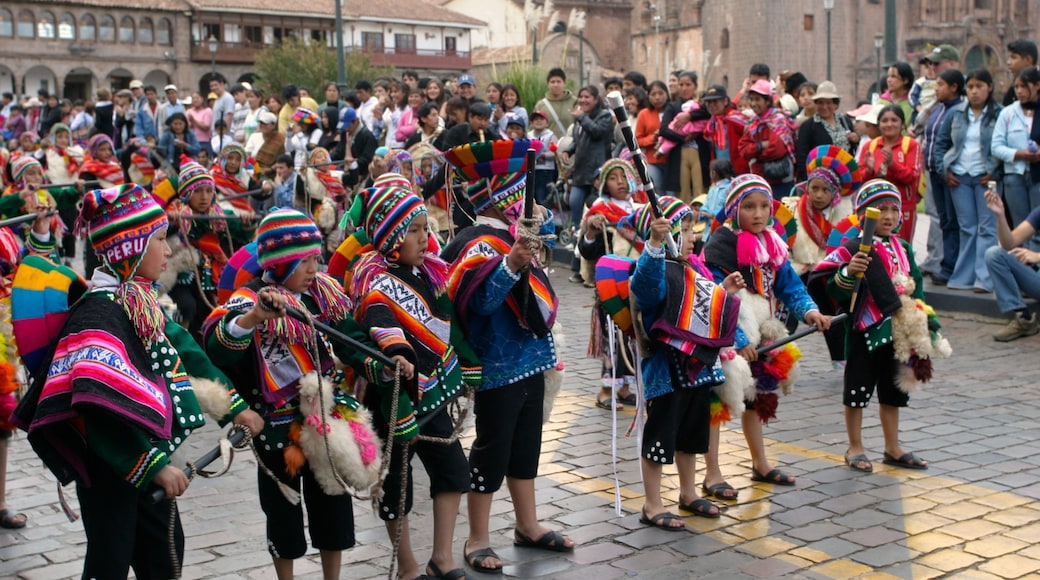 Cusco showing performance art, a festival and street performance