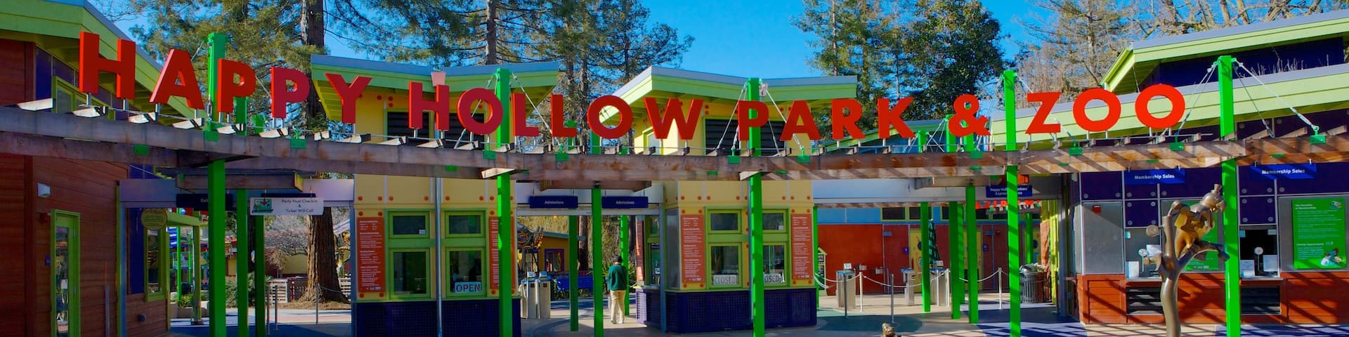 Happy Hollow Park and Zoo showing signage, a park and zoo animals
