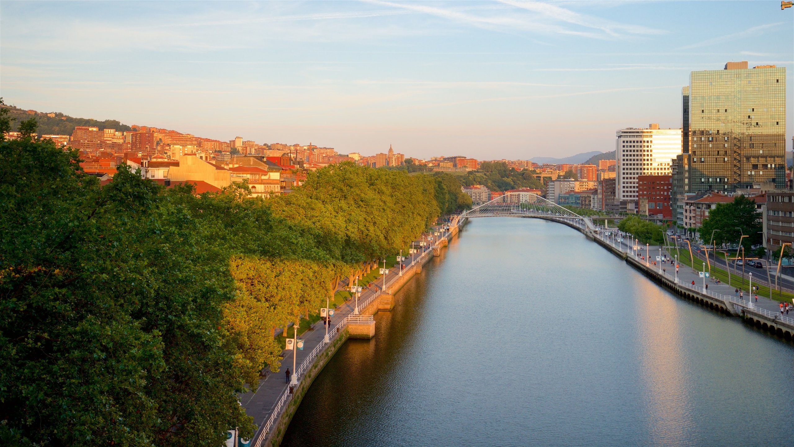 Bilbao showing a river or creek, a city and a sunset