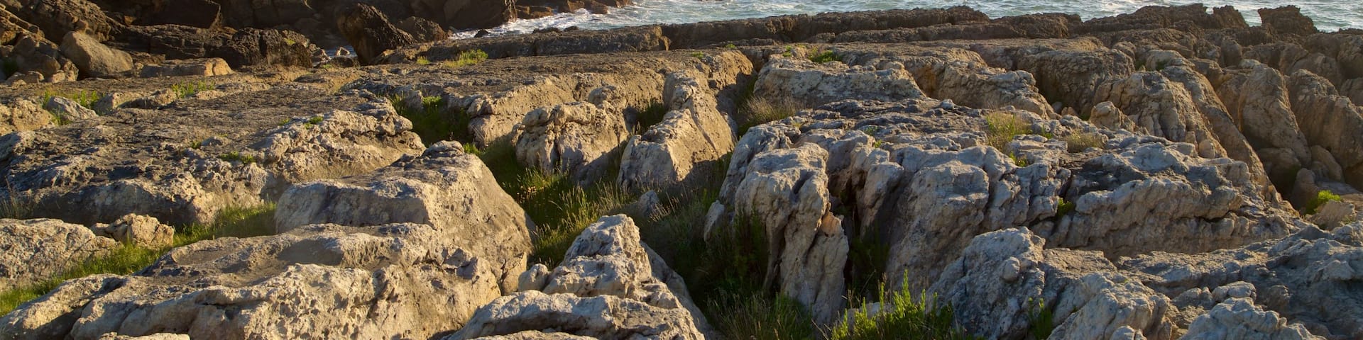 Santander - Cantabrian Coast which includes rocky coastline, a sunset and general coastal views