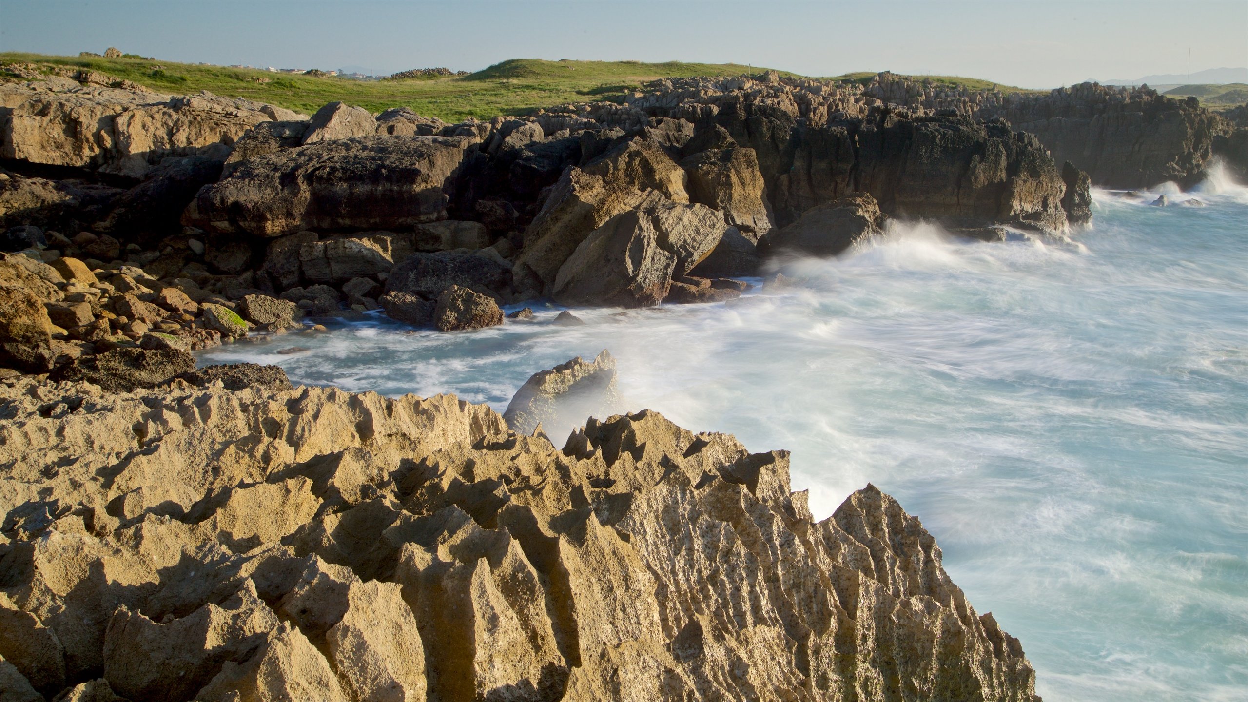 Santander which includes a sunset, rugged coastline and general coastal views