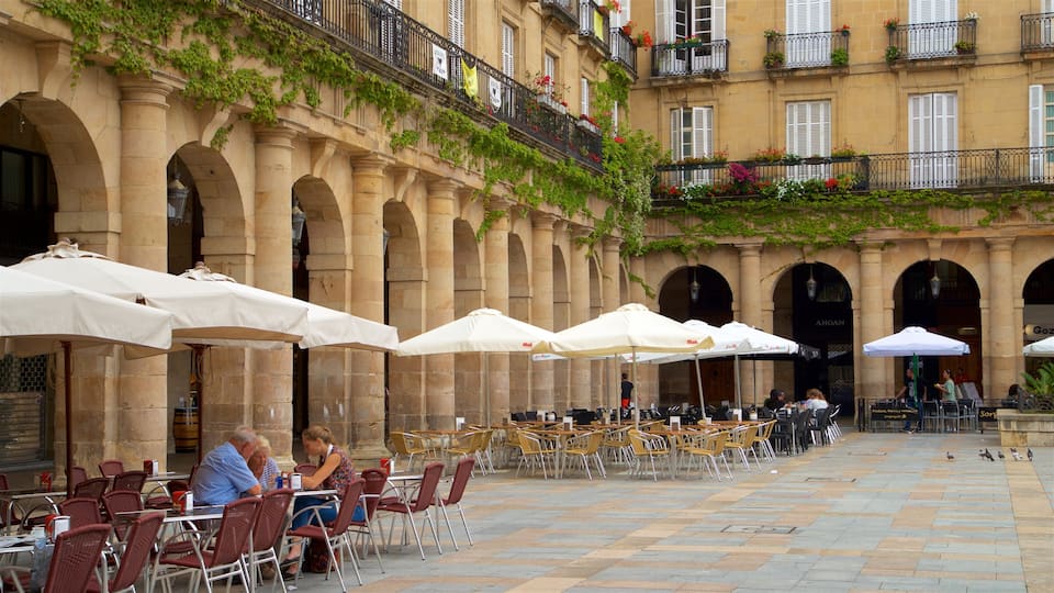 Plaza Nueva showing heritage elements and outdoor eating as well as a small group of people