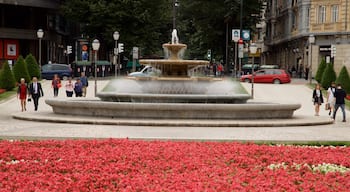 Plaza Moyua which includes flowers, a fountain and a garden