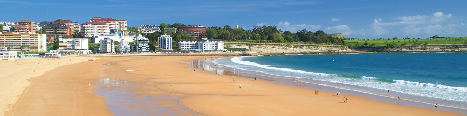 Camello Beach which includes a city, a beach and a coastal town