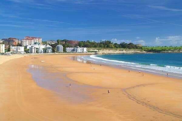 Camello Beach which includes a city, a beach and a coastal town