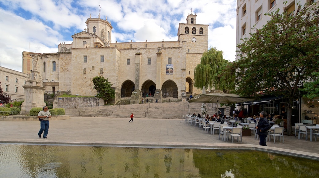 Santander Cathedral showing a statue or sculpture, a pond and heritage architecture