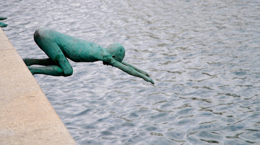 Monumento a Los Raqueros showing a statue or sculpture, outdoor art and a bay or harbor