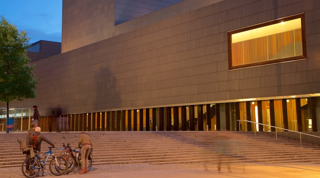 Palacio de Congresos and Auditorium of Navarra featuring street scenes and night scenes as well as a small group of people