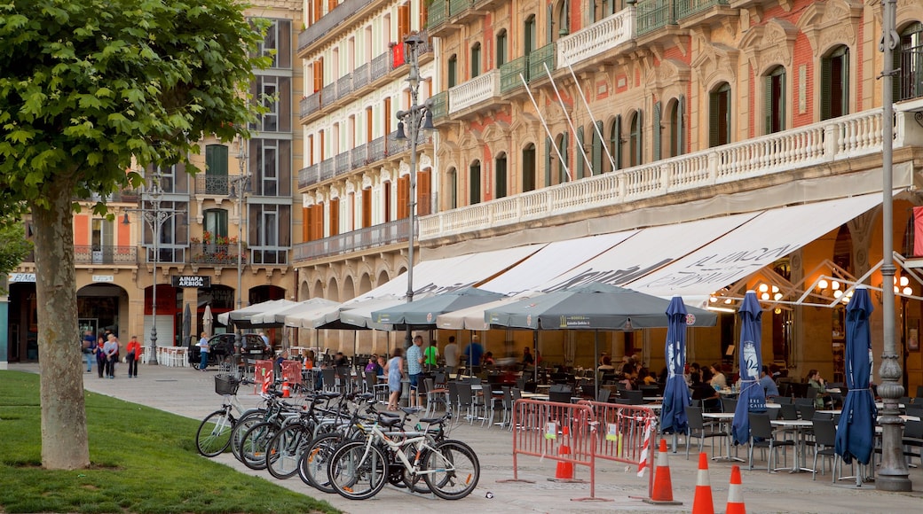 Plaza del Castillo which includes outdoor eating as well as a small group of people