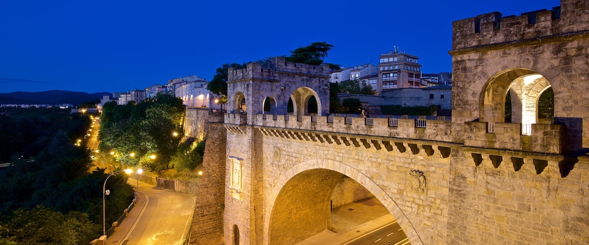 Pamplona\'s City Walls and Interpretation Centre featuring heritage architecture, night scenes and a bridge