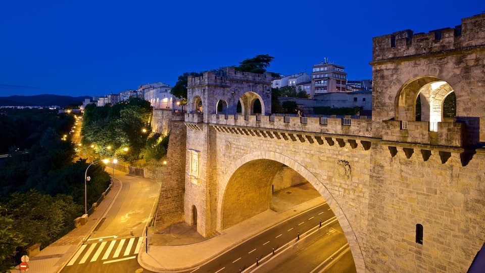 Pamplona\'s City Walls and Interpretation Centre featuring a bridge, heritage architecture and night scenes