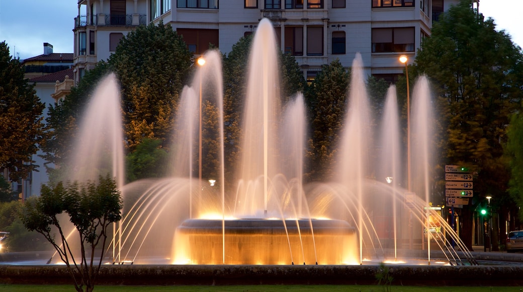 Plaza Principe de Viana showing night scenes, a fountain and a garden