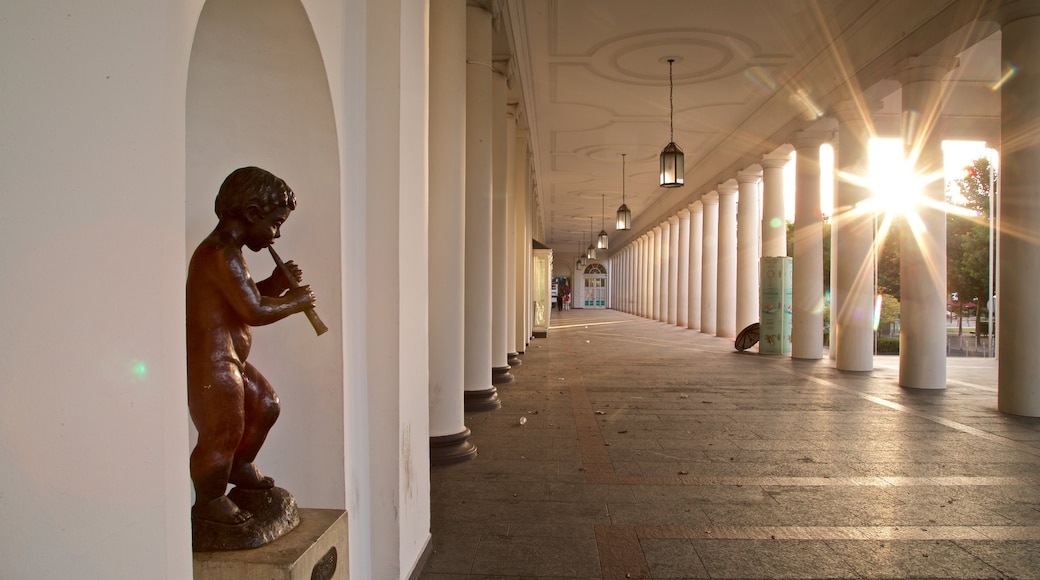 Hessian State Theatre showing a statue or sculpture and a sunset