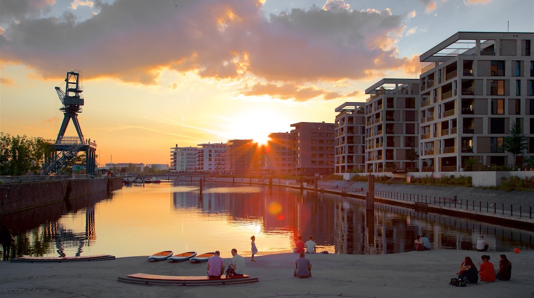 Offenbach am Main featuring a sunset and a bay or harbour as well as a small group of people