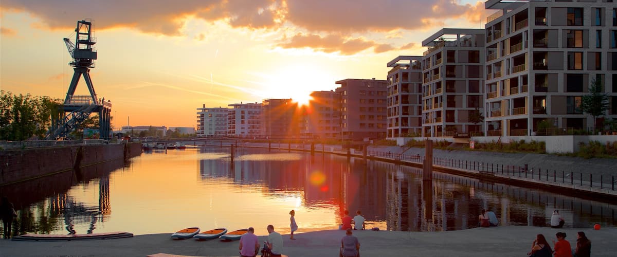 Offenbach am Main featuring a sunset and a bay or harbour as well as a small group of people