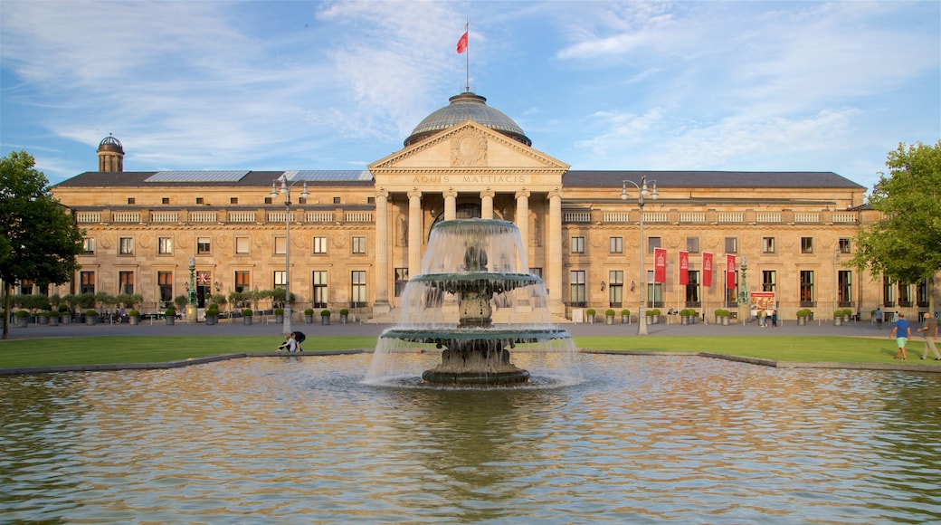 Kurhaus showing heritage architecture, a fountain and a garden