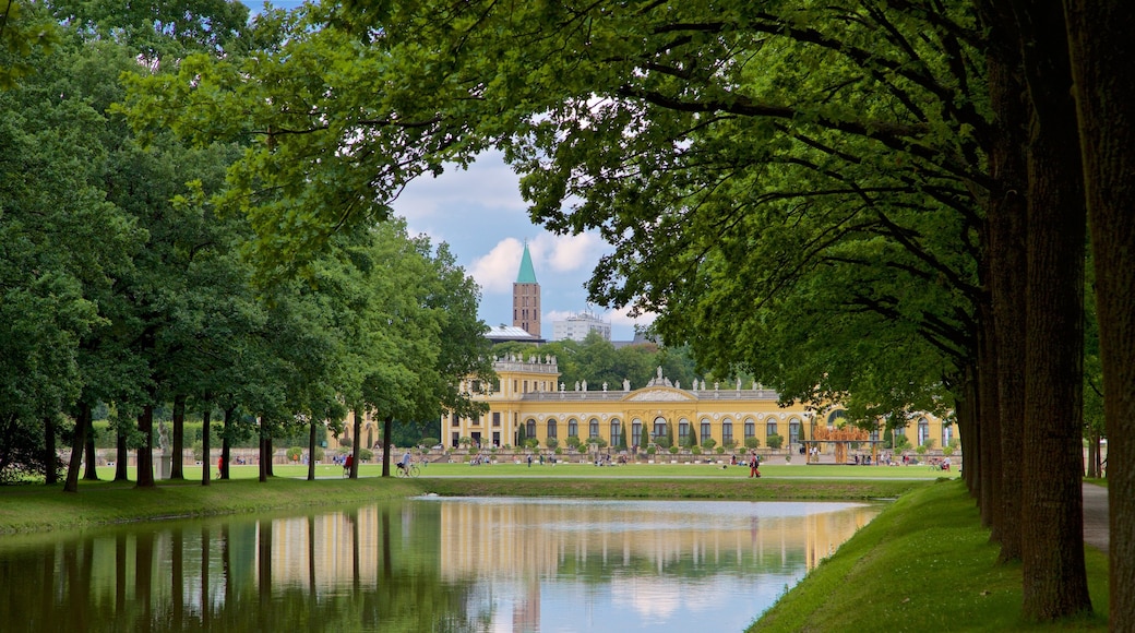 Karlsaue Park featuring a river or creek, heritage architecture and a garden