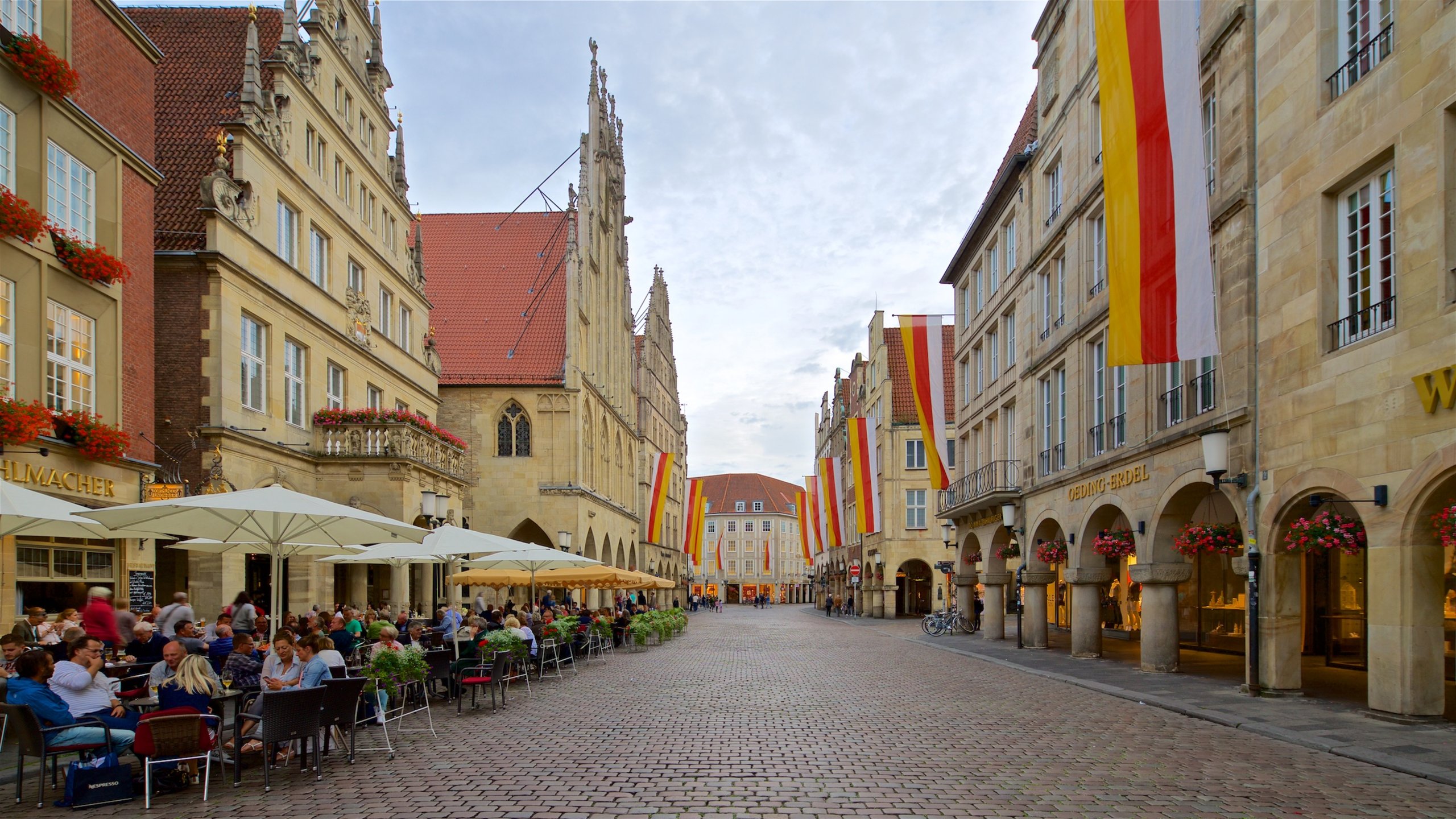 Muenster which includes heritage elements and outdoor eating as well as a small group of people