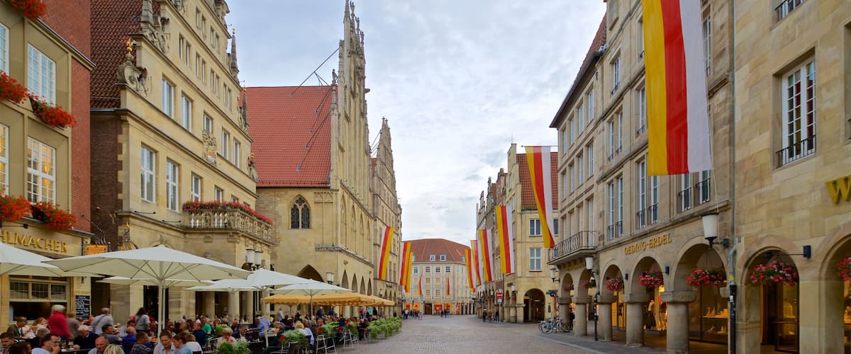 Muenster showing outdoor eating and heritage elements as well as a small group of people