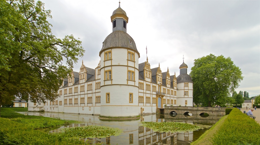 Neuhaus Castle featuring a bridge, a pond and heritage architecture