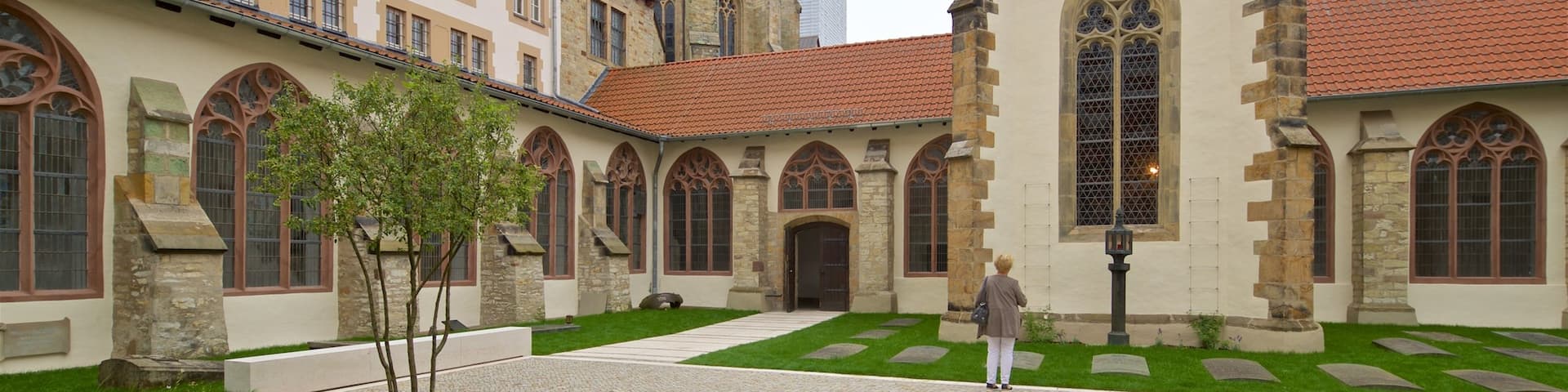 Paderborn Cathedral featuring street scenes and heritage elements as well as an individual femail