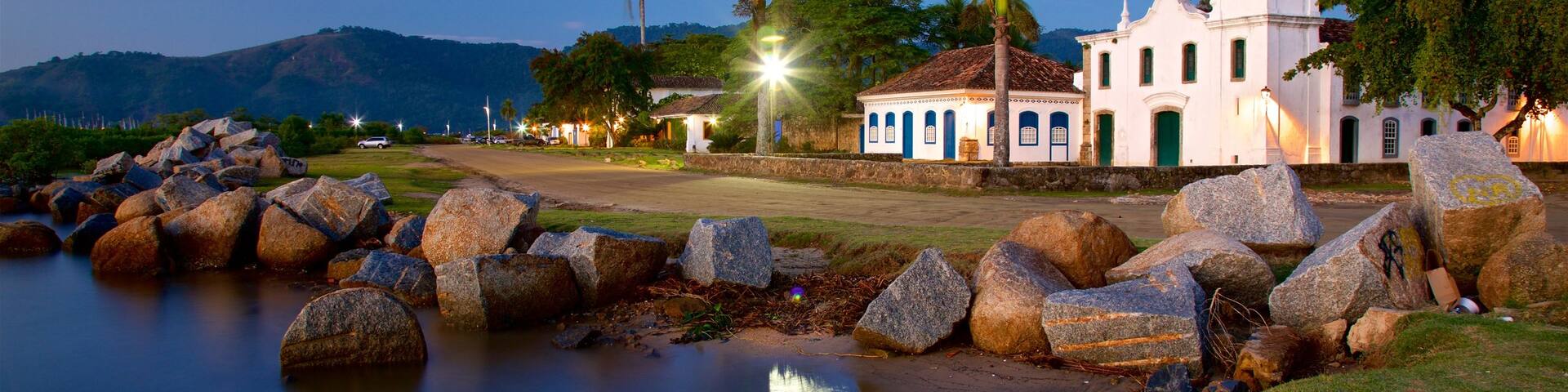 Nossa Senhora das Dores Church showing night scenes, a lake or waterhole and a small town or village