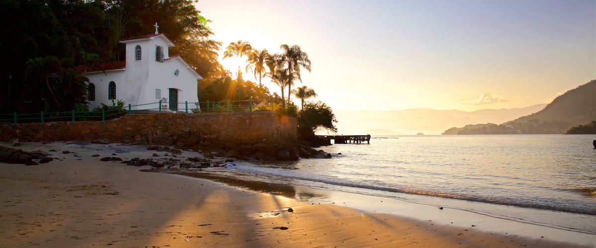 Gipoia Island featuring a beach, a church or cathedral and a sunset