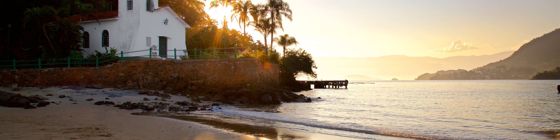 Gipoia Island featuring a beach, a church or cathedral and a sunset