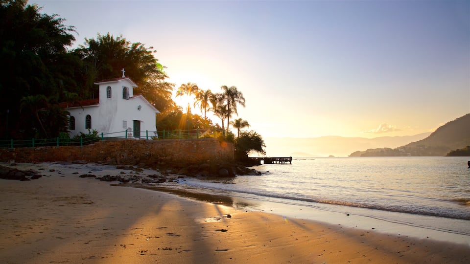 Gipoia Island which includes a sunset, a sandy beach and general coastal views