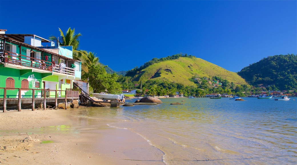 Enseada Beach which includes a coastal town, a bay or harbor and general coastal views