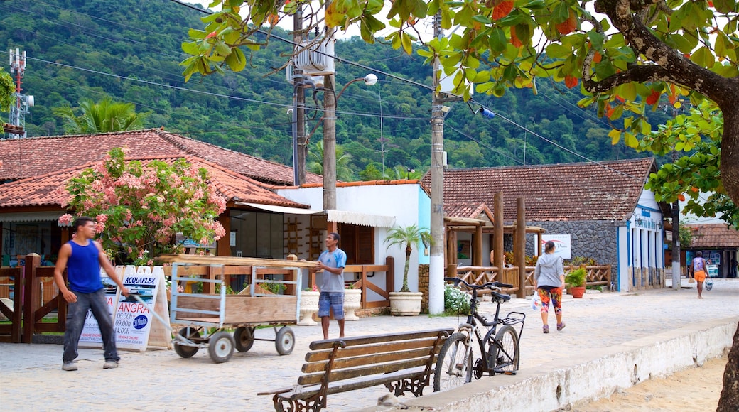 Vila do Abraao featuring a small town or village and street scenes as well as a small group of people