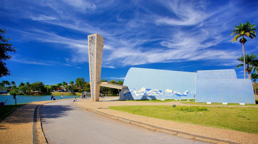 Church of Saint Francis of Assisi which includes outdoor art, a garden and a lake or waterhole