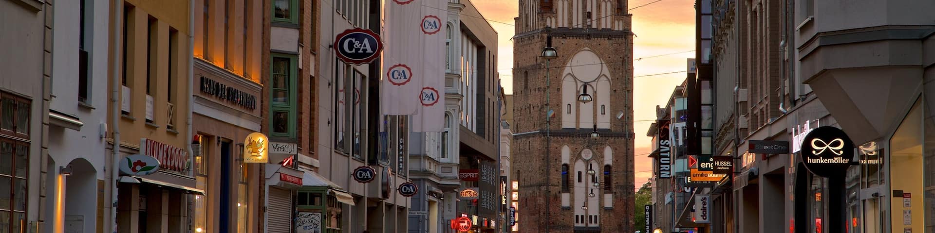Kröpeliner Tor which includes heritage architecture, a sunset and a city