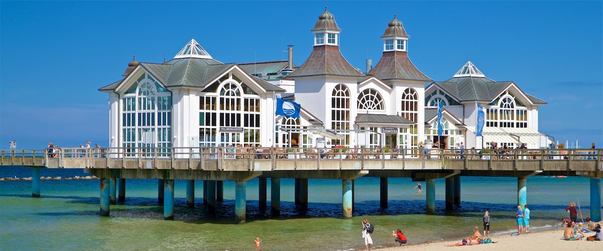 Sellin Pier featuring a beach and general coastal views as well as a small group of people