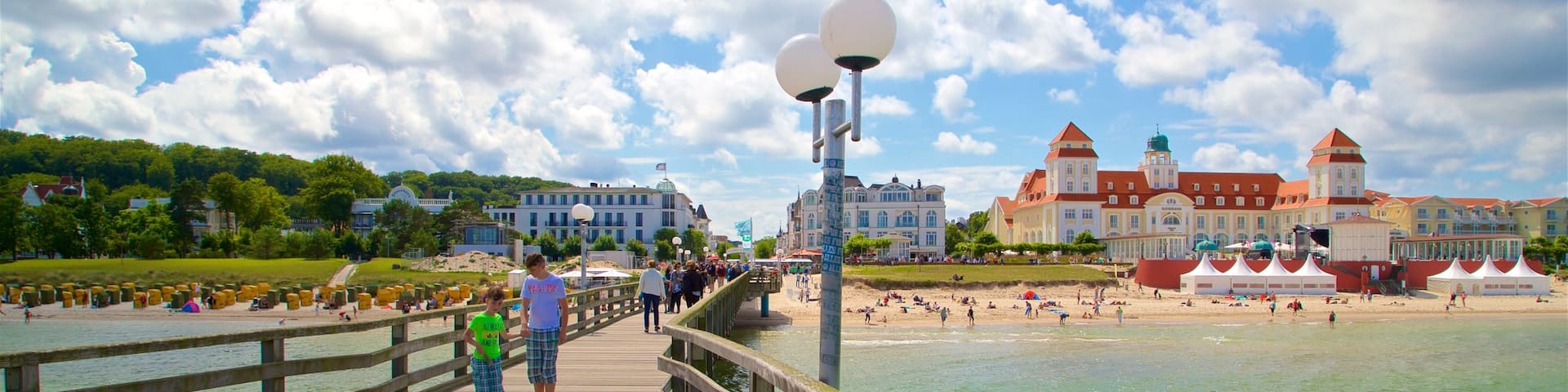 Binz Pier which includes general coastal views and a coastal town as well as a couple