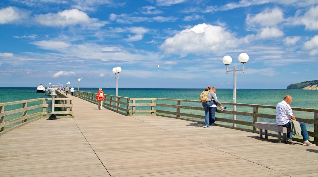 Binz Pier featuring general coastal views as well as a small group of people