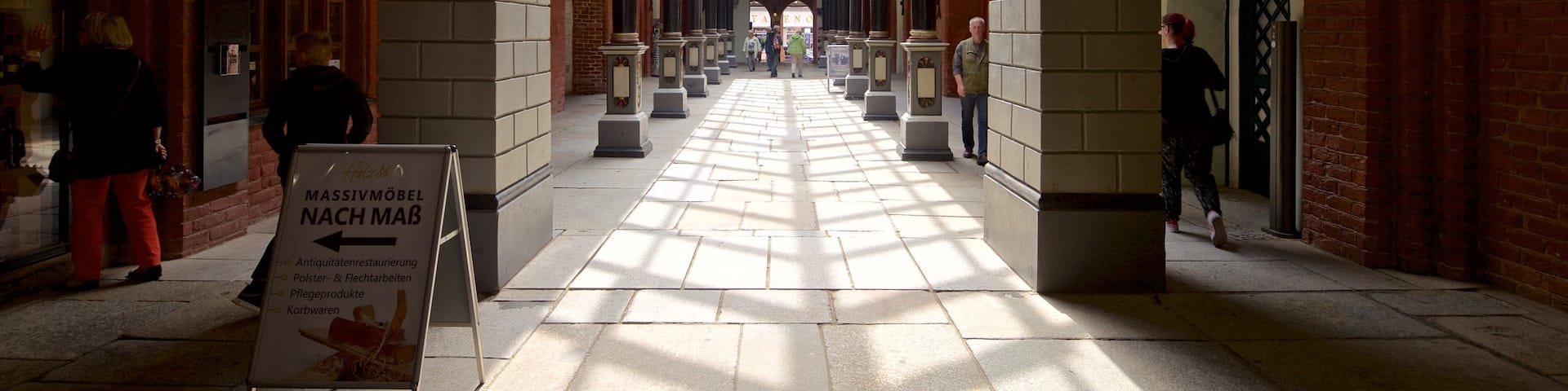 Rathaus featuring signage and interior views as well as a small group of people