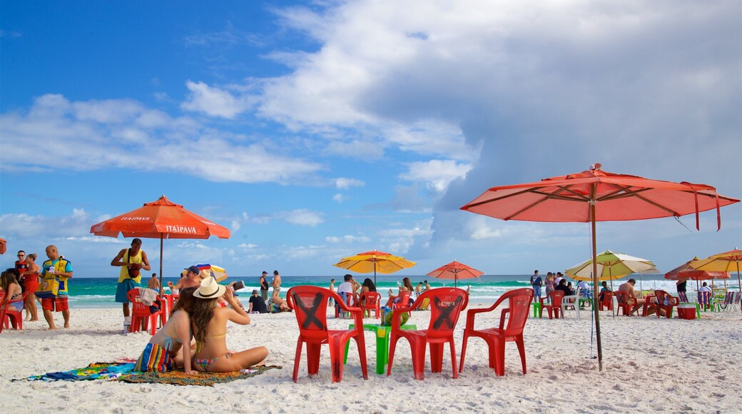 Arraial do Cabo featuring a sandy beach and general coastal views as well as a small group of people