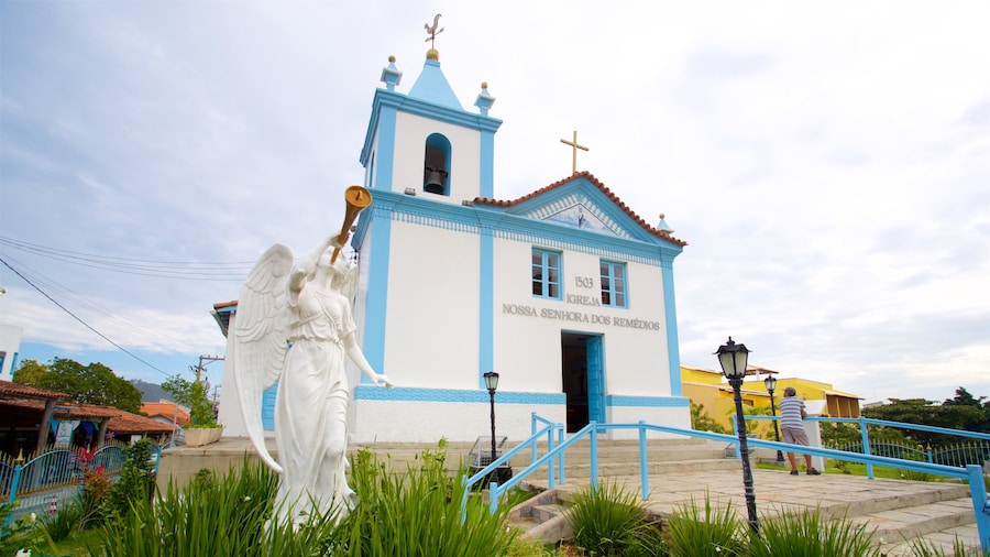 Our Lady of Remedies Church which includes a church or cathedral, religious elements and a statue or sculpture