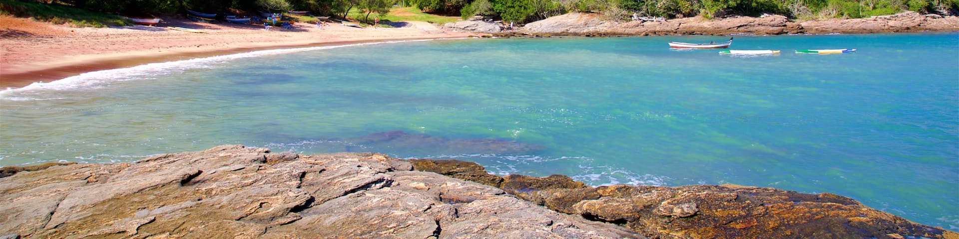 Forno Beach which includes a sandy beach, general coastal views and rugged coastline