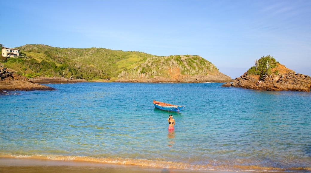 Ferradura Beach featuring rocky coastline, general coastal views and swimming