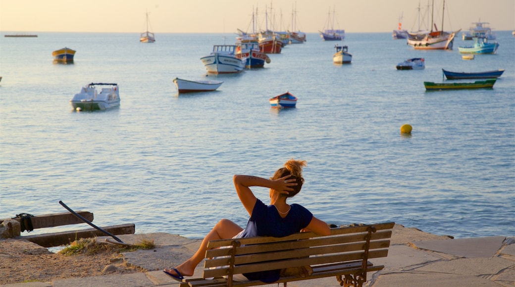 Orla Bardot mostrando vista general a la costa y una bahía o un puerto y también una mujer