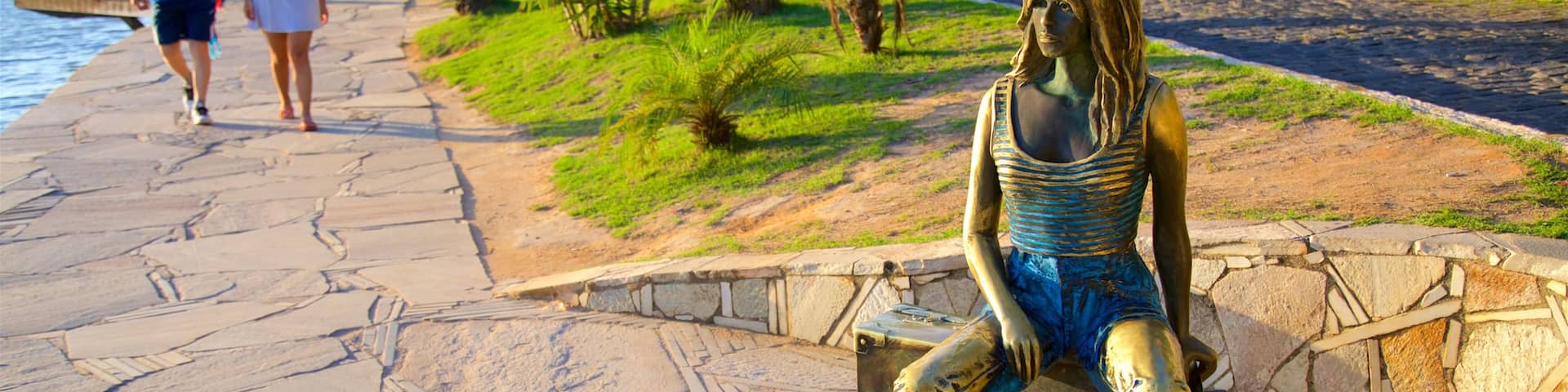 Brigitte Bardot Statue which includes a statue or sculpture and outdoor art as well as a couple