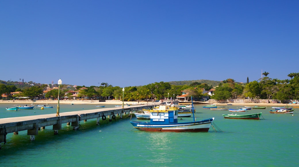 Manguinhos Beach which includes general coastal views, a coastal town and a bay or harbour