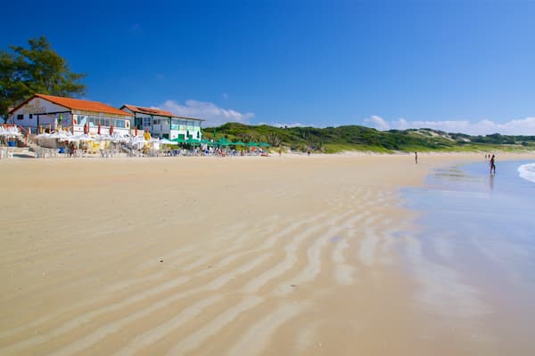 Conchas Beach which includes a coastal town, general coastal views and a beach