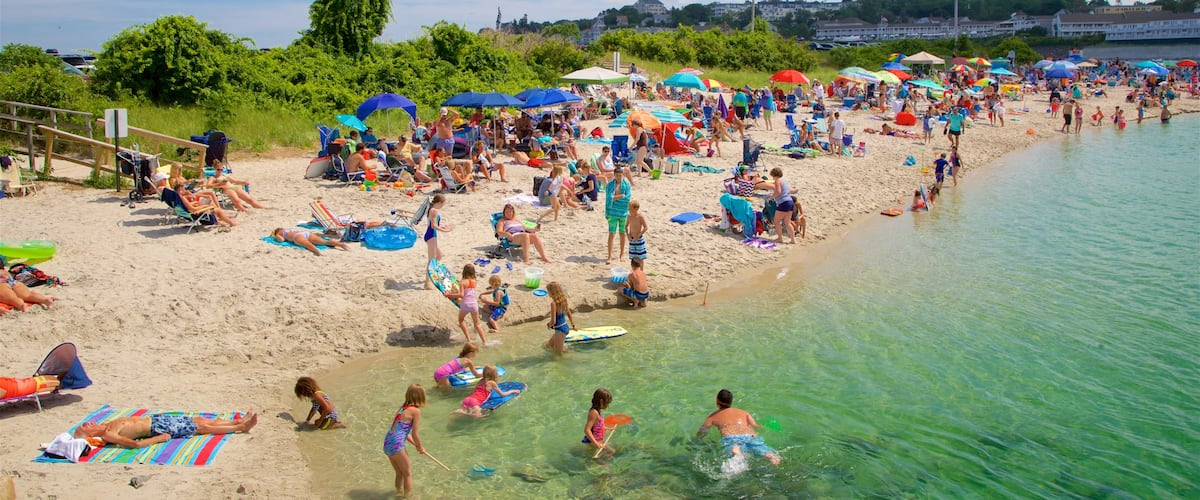 Ogunquit Beach which includes a beach and general coastal views as well as a large group of people