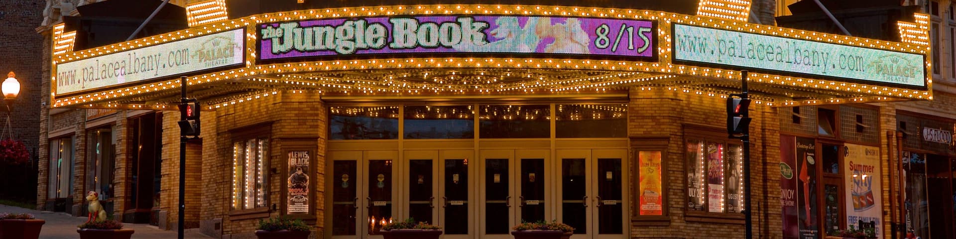Palace Theater featuring signage and night scenes